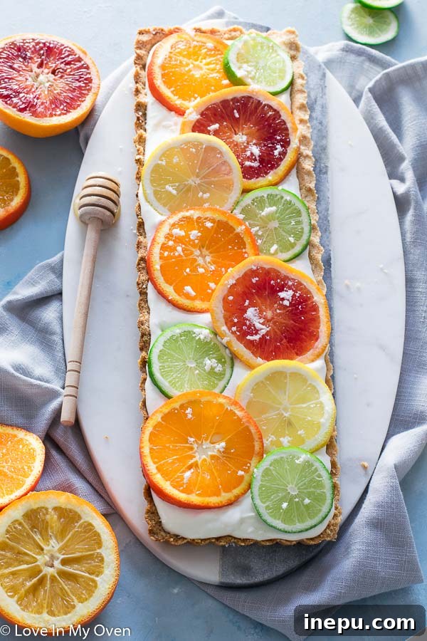 Slice of sunny citrus tart showing the grain-free crust and creamy filling