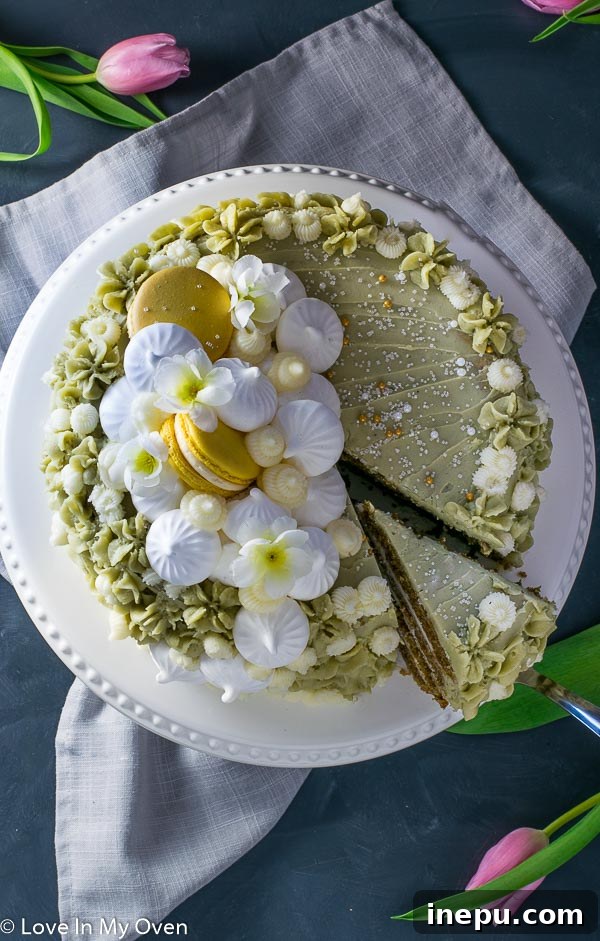 Slice of Matcha Vanilla Cake with vanilla and matcha frosting