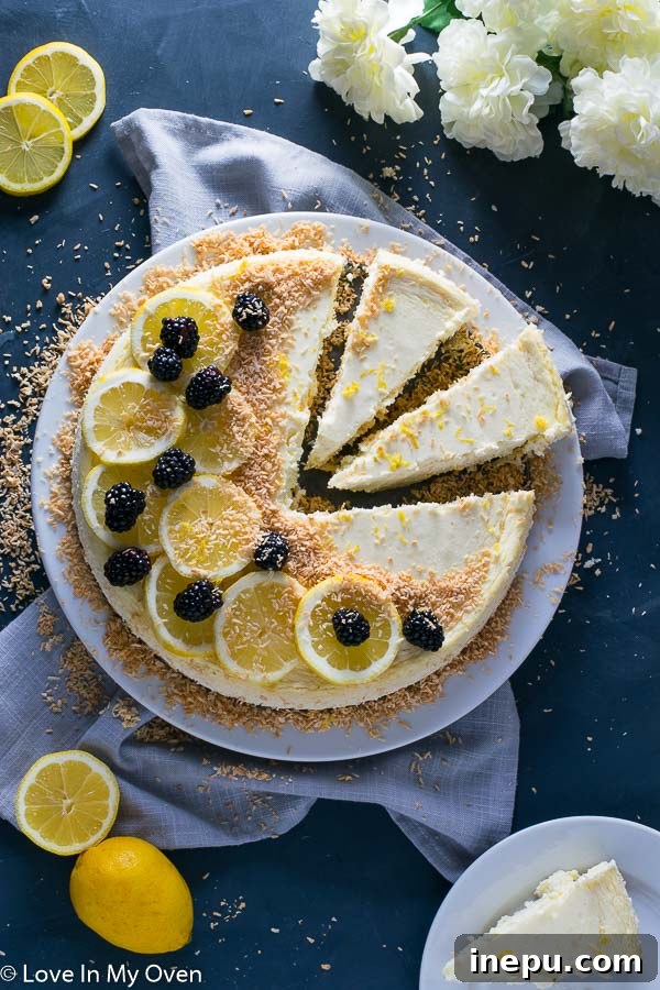 Full Keto Coconut Lemon Cheesecake garnished with toasted coconut