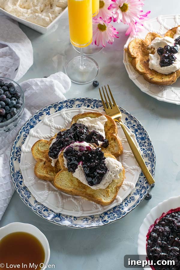 Close-up of Earl Grey French Toast with layers of whipped cream and compote