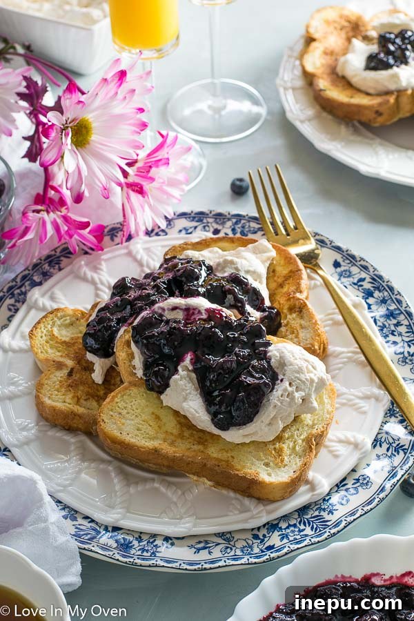 French toast garnished with berries and tea