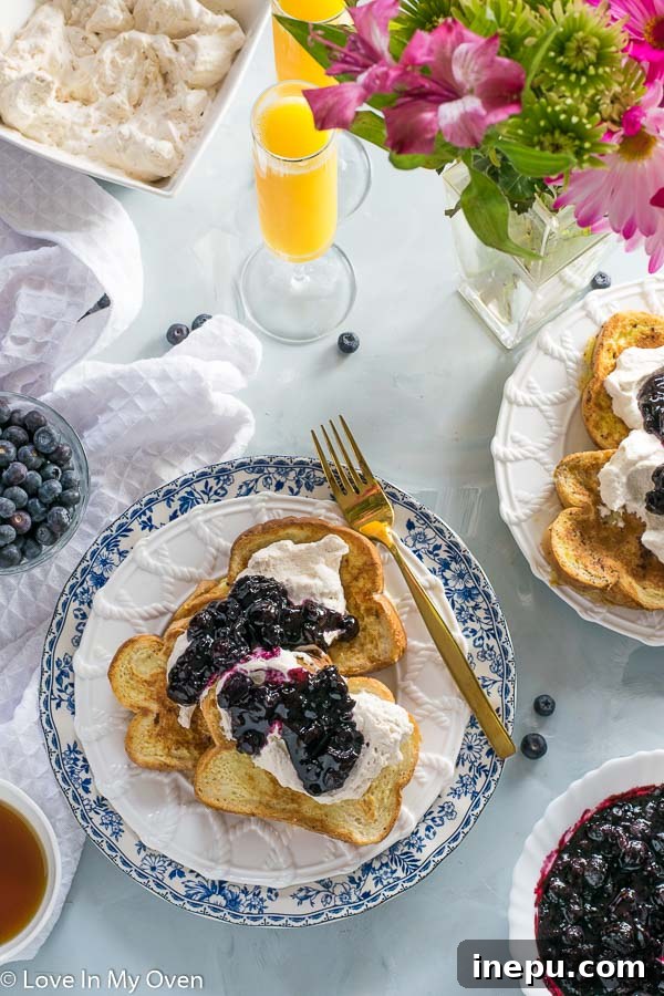 Overhead view of French toast with Earl Grey whipped cream and blueberry compote