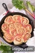 Rhubarb Streusel Rolls: A close-up of a beautifully glazed roll, ready to be served.