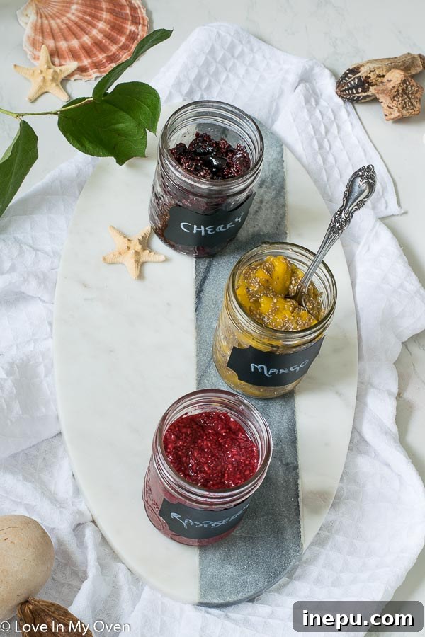 Assortment of fresh fruits and a jar of homemade 3-ingredient chia jam, perfect for breakfast.