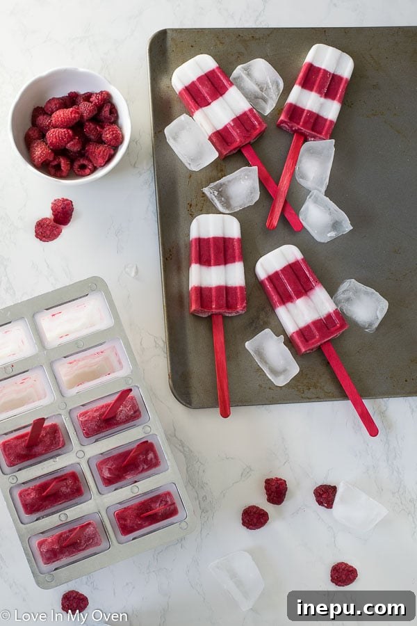 Raspberry Coconut Frozen Delights 3 Layered healthy raspberry coconut popsicles in a glass