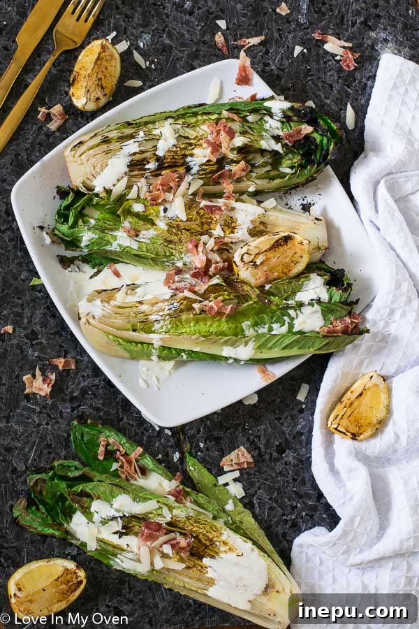 Smoky Romaine Caesar 2 Grilled Romaine Caesar Salad on a rustic wooden board with fresh lemon and herbs, ready to be served