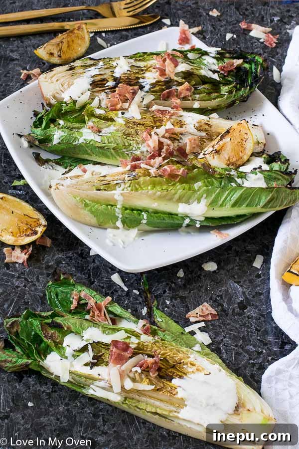 Smoky Romaine Caesar 3 Two plates of perfectly grilled romaine Caesar salad, artfully arranged and topped with crispy bacon and shaved parmesan