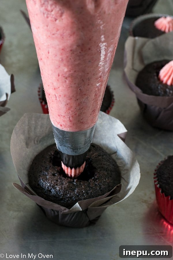 Strawberry S'mores Dream Cupcakes 6 Filling a chocolate cupcake with strawberry buttercream