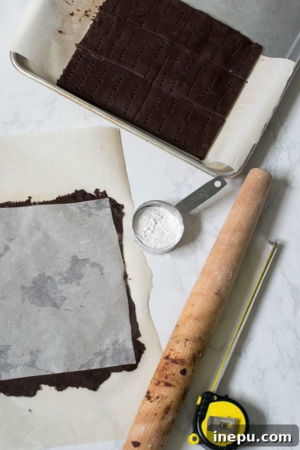 Freshly baked chocolate cookies for ice cream sandwiches, laid out on parchment paper to cool.