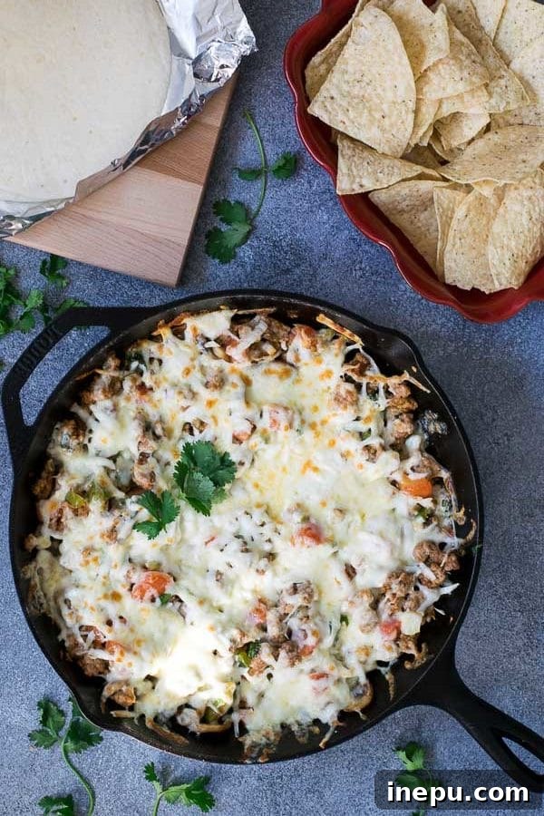 Delicious grilled Queso Fundido with chorizo in a cast iron skillet, ready to serve.