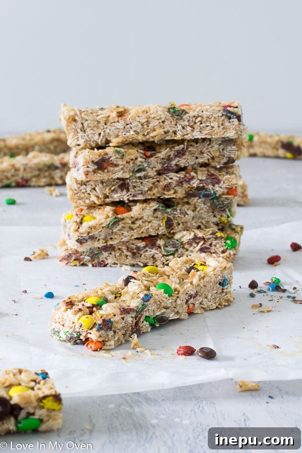 A close-up of a stack of M&M granola bars, highlighting the colorful candy pieces.