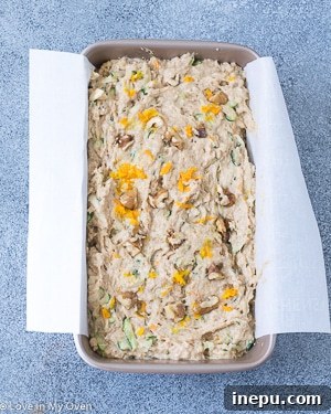 Two slices of Orange Zucchini Bread on a white plate