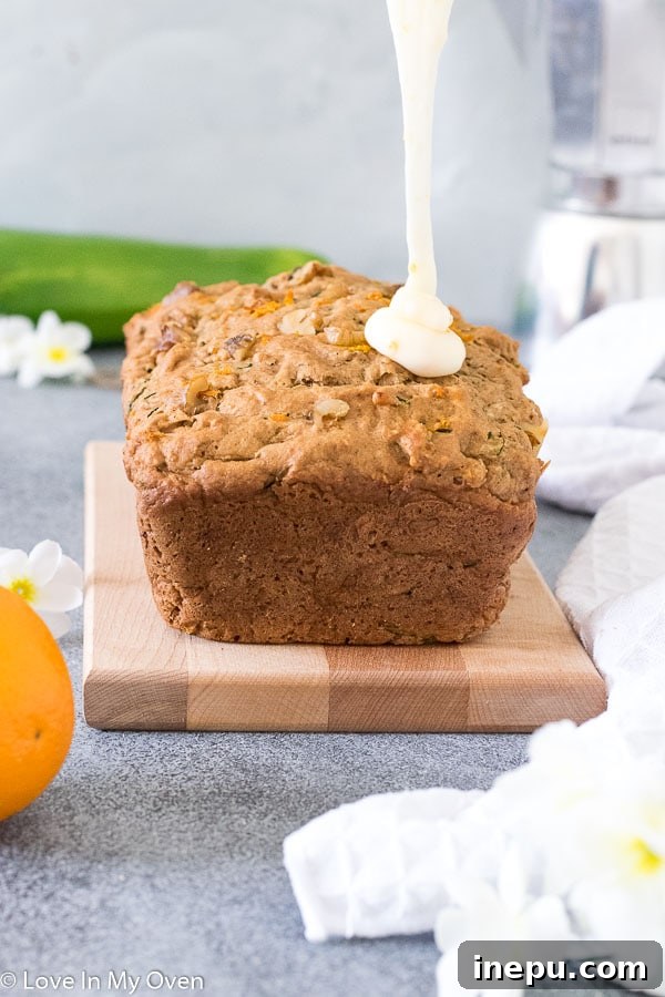 Two slices of Orange Zucchini Bread on a wooden board