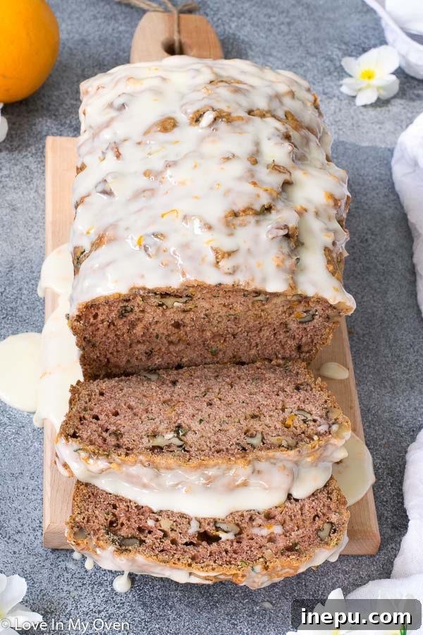 Sliced Orange Zucchini Bread on a cutting board, ready to serve