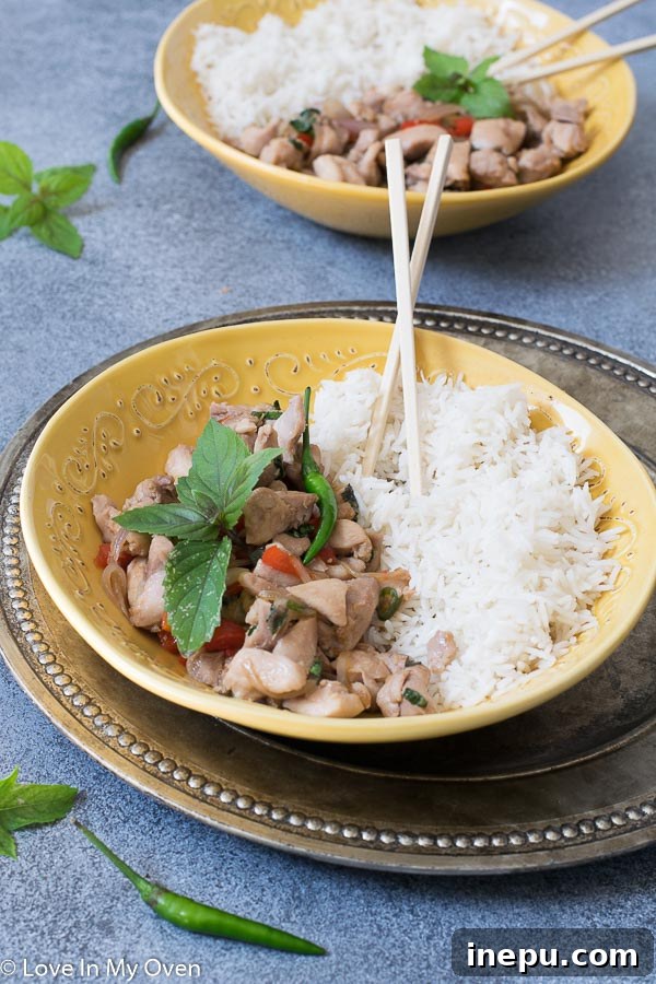 Fresh ingredients for easy Thai basil chicken, including diced chicken, garlic, chilies, and bell pepper.