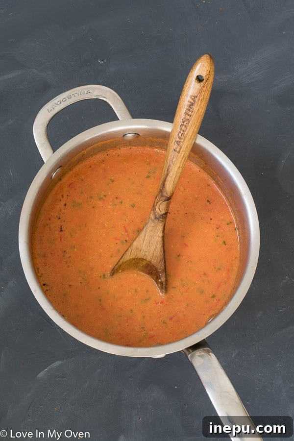 Sun-Kissed Tomato Basil Bisque 5 Creamy Roasted Tomato Basil Soup served in a bowl with fresh basil garnish