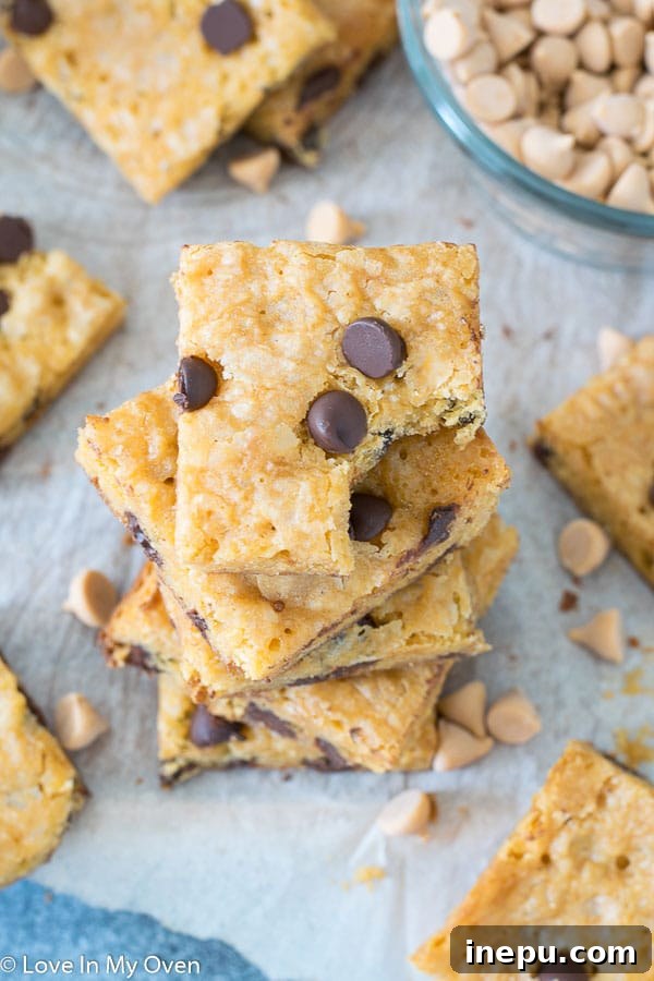 Freshly baked golden butterscotch brownies, cooling in a parchment-lined pan.
