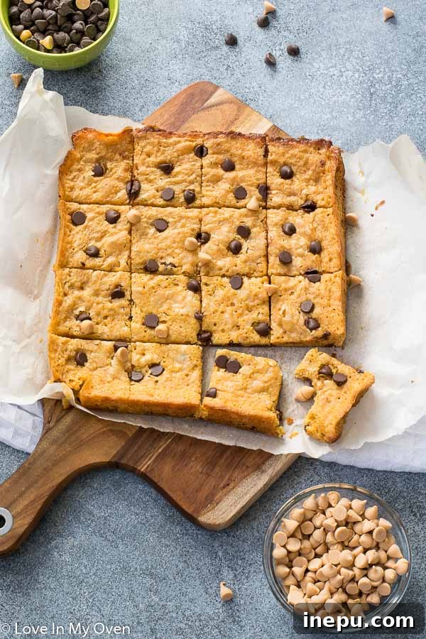 A close-up of a square butterscotch brownie, showcasing its chewy texture and melted chocolate chips.