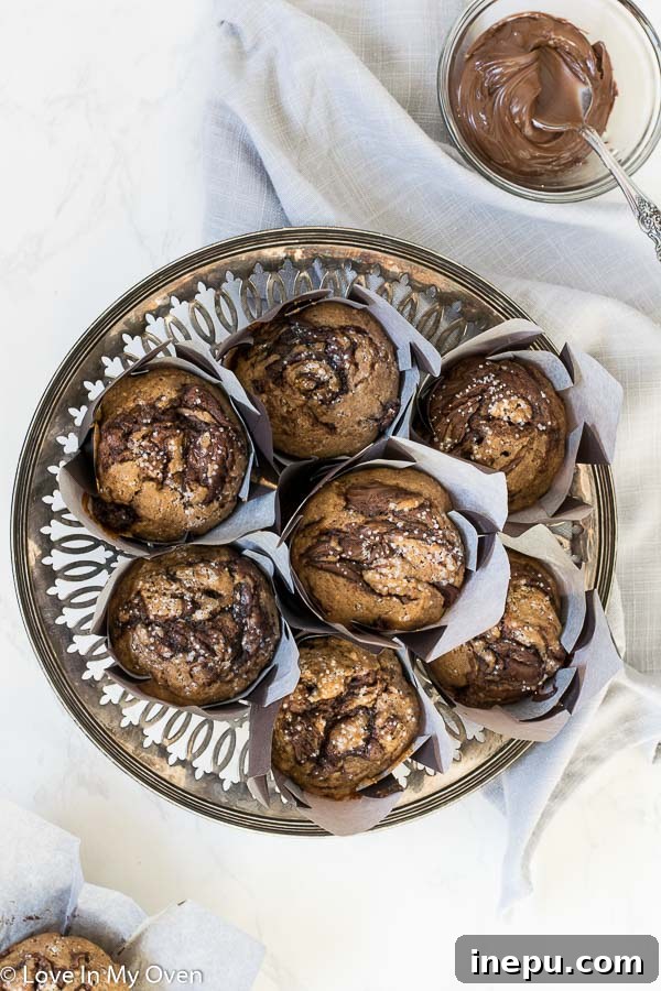 Close-up of a perfectly swirled Nutella muffin, revealing the rich chocolate-hazelnut and cinnamon pattern.