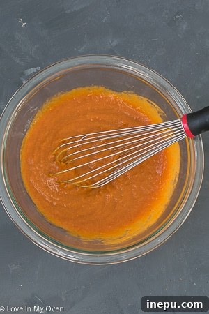 Spiced Pumpkin Bites 4 Whisking wet ingredients for mini pumpkin muffins with maple syrup