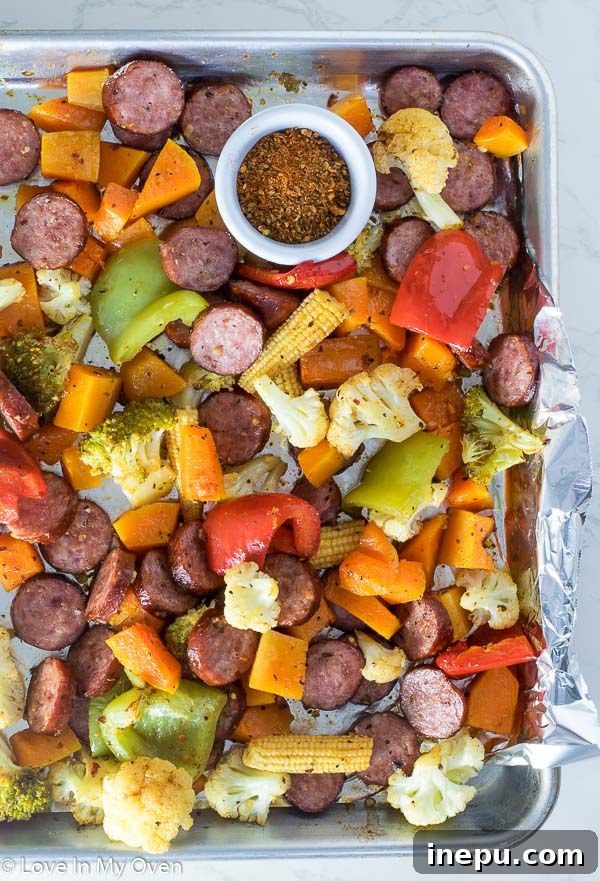 Delicious one-pan sausage and roasted vegetables dinner on a baking sheet