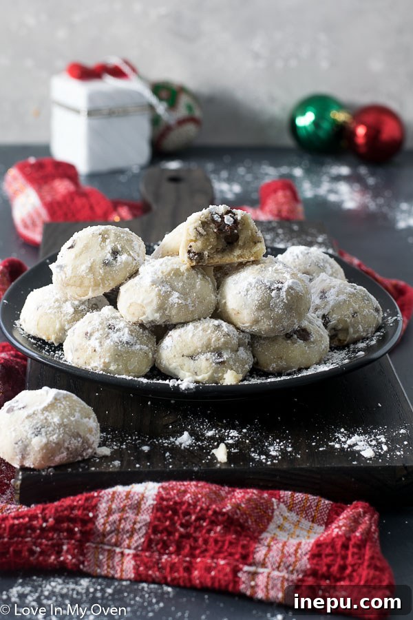 Delightful chocolate chip snowball cookies dusted with powdered sugar, ready for the holidays.