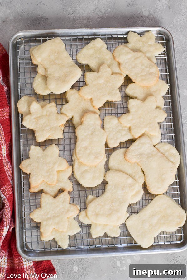 shortbread cookies cut into shapes on a baking sheet