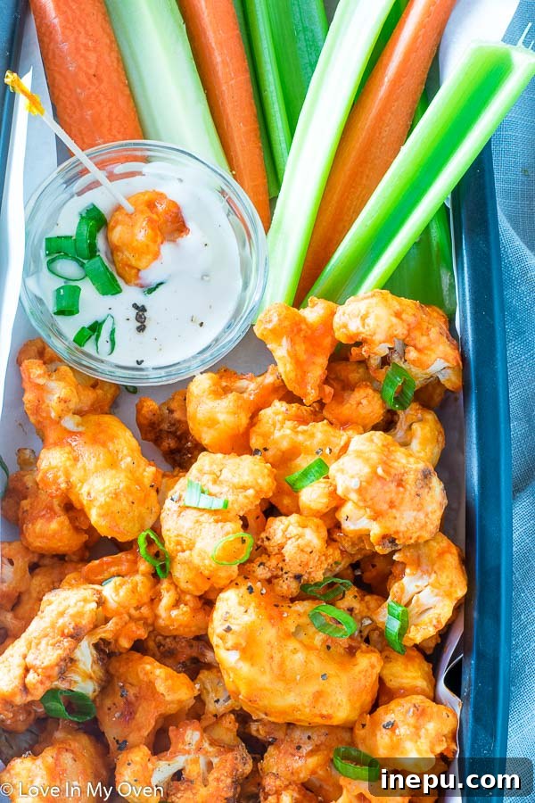 Crispy Air Fryer Buffalo Cauliflower Wings 8 Delicious Air Fryer Buffalo Cauliflower with a dipping sauce, close-up shot.