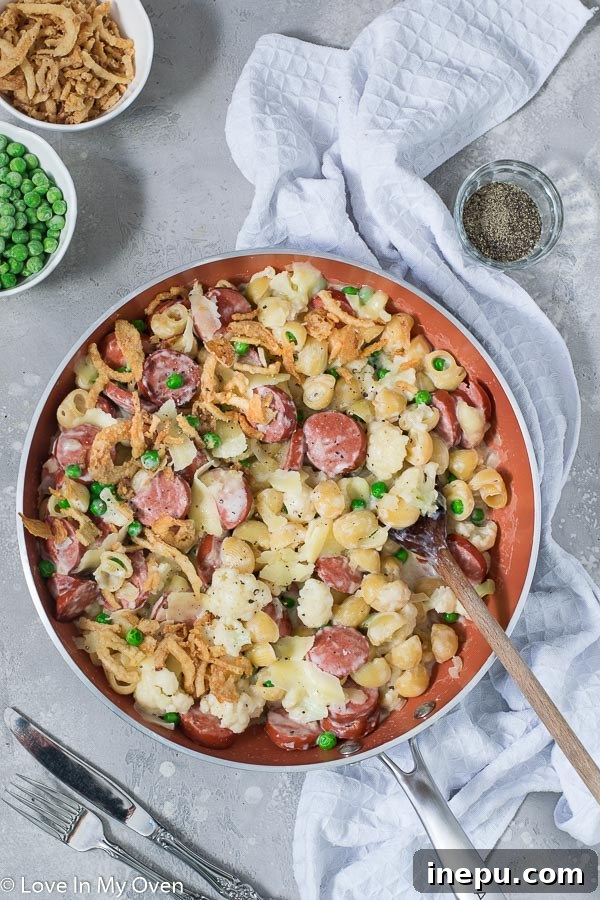 scoop of veggie and sausage pasta skillet in a bowl