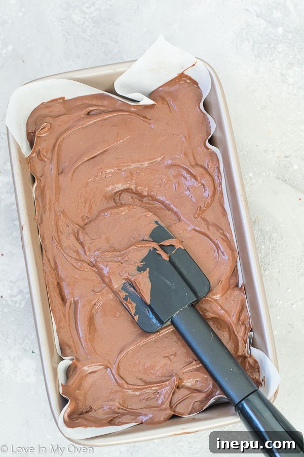 Folding sweetened condensed coconut milk into the chocolate coconut cream mixture