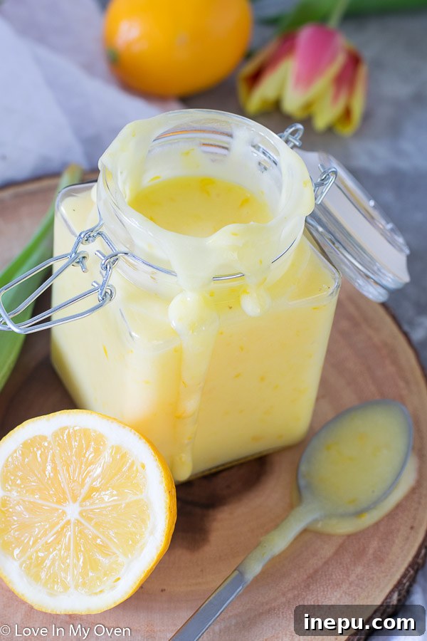 Meyer lemon curd in a bowl with a spoon