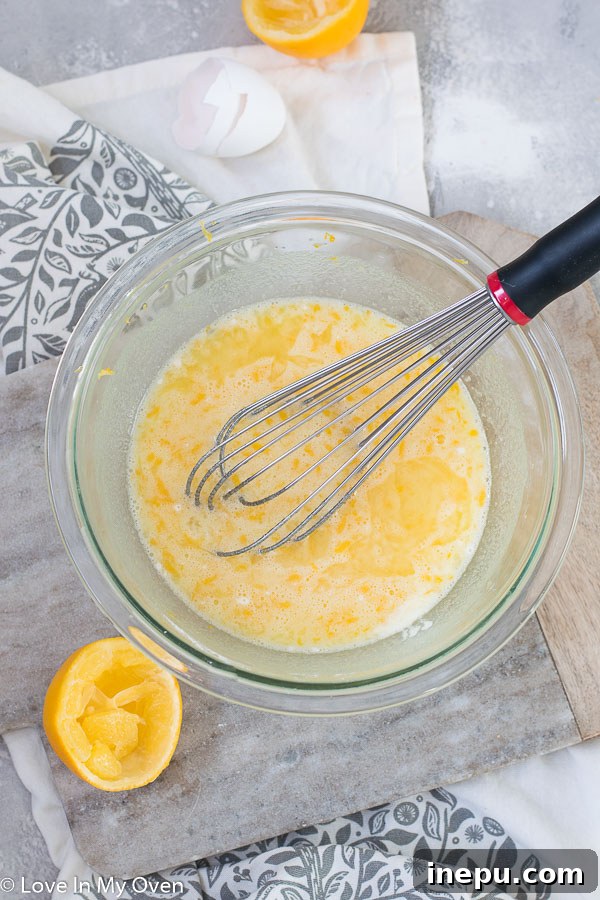 Bright Meyer Lemon Dream Bars 5 Meyer lemon filling ingredients being whisked in a bowl.