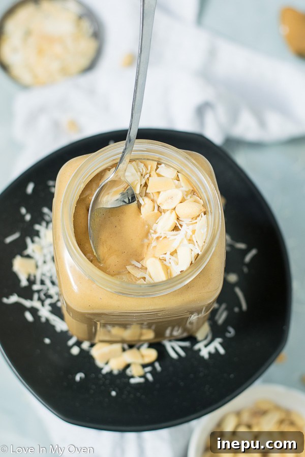 Tropical Nut Butter Bliss 3 Jar of homemade coconut peanut butter with shredded coconut next to it