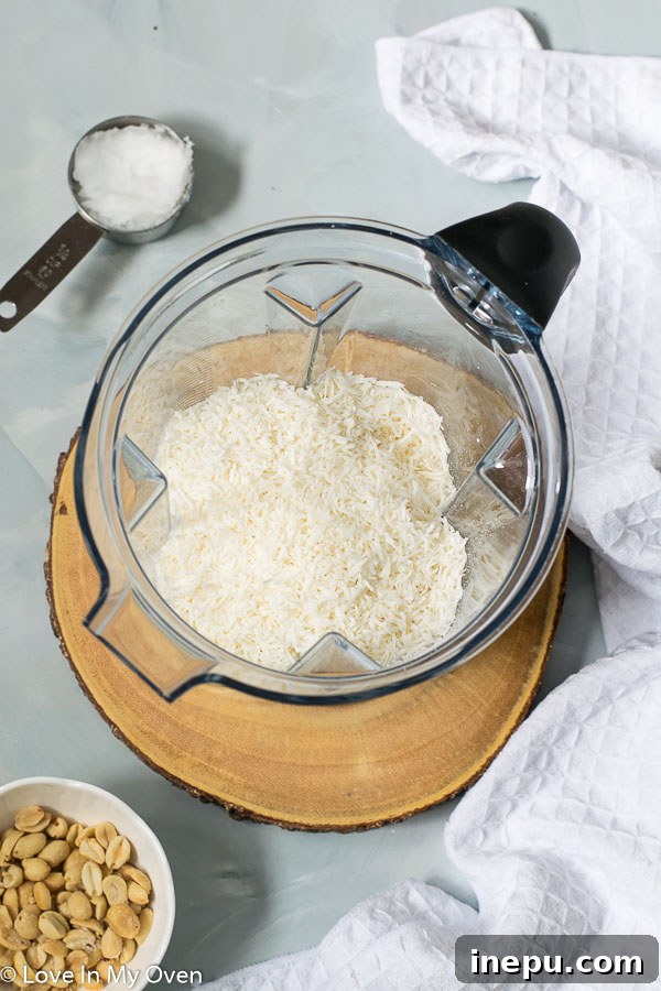 Tropical Nut Butter Bliss 4 Shredded coconut inside a food processor before blending