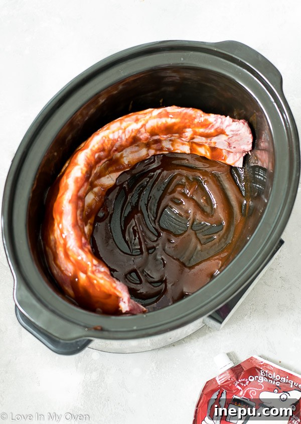 Melt-in-Your-Mouth Slow Cooker Ribs 5 Ribs cooking on low in a slow cooker