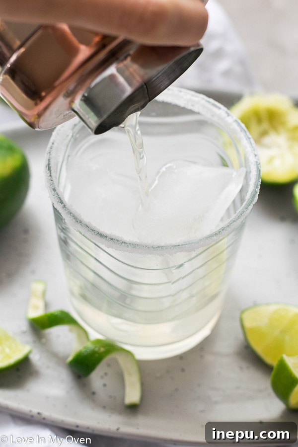The Essential Margarita 3 Ingredients for a simple margarita including tequila, Cointreau, and fresh limes