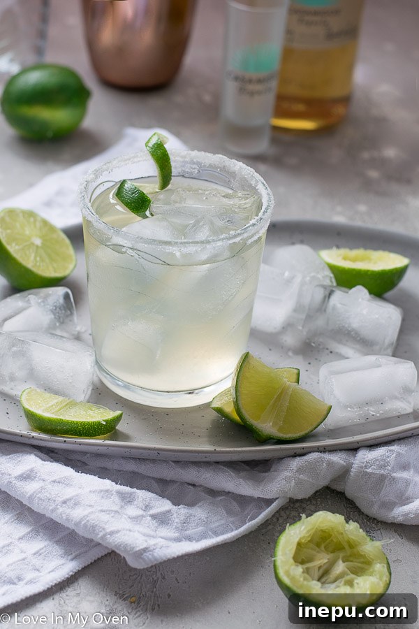 The Essential Margarita 6 Overhead shot of two simple margaritas with limes