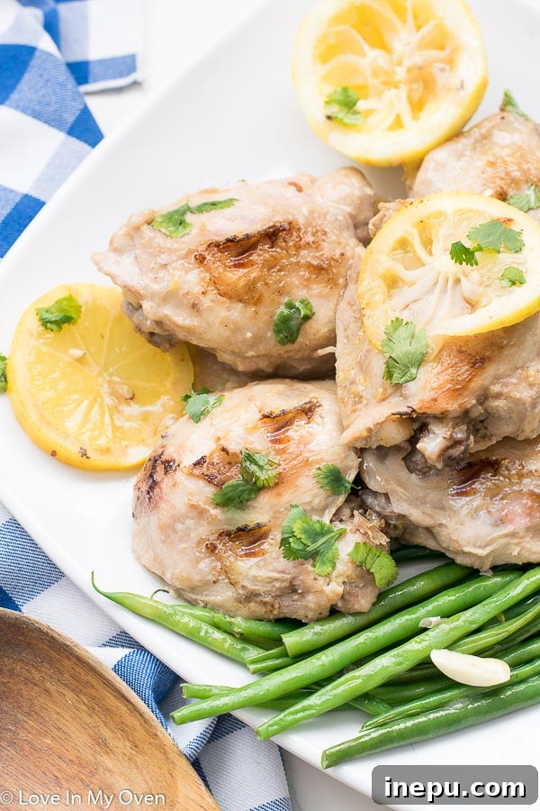 Instant Pot Lemon Garlic Chicken Thighs plated with fresh parsley