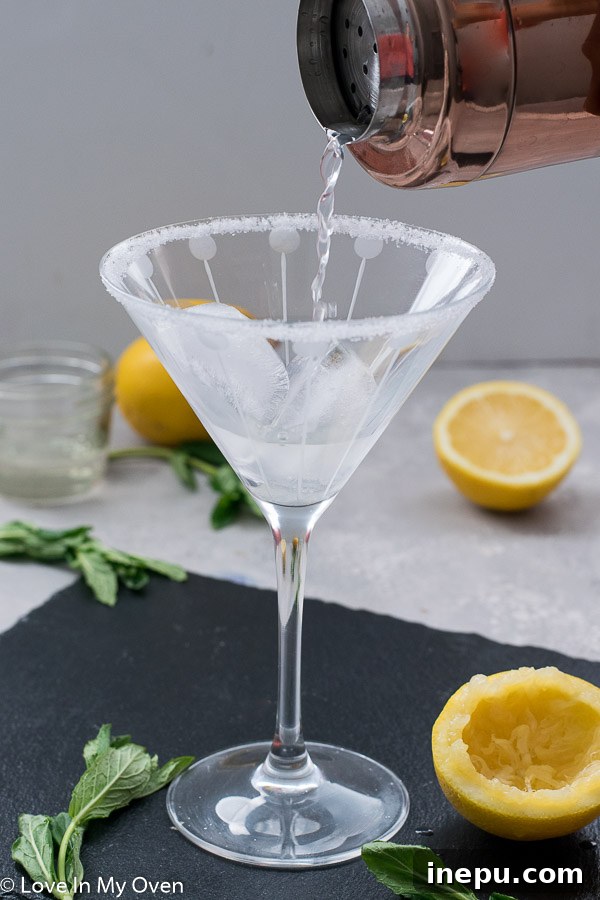 Lemon vodka cocktail being shaken in a cocktail shaker.