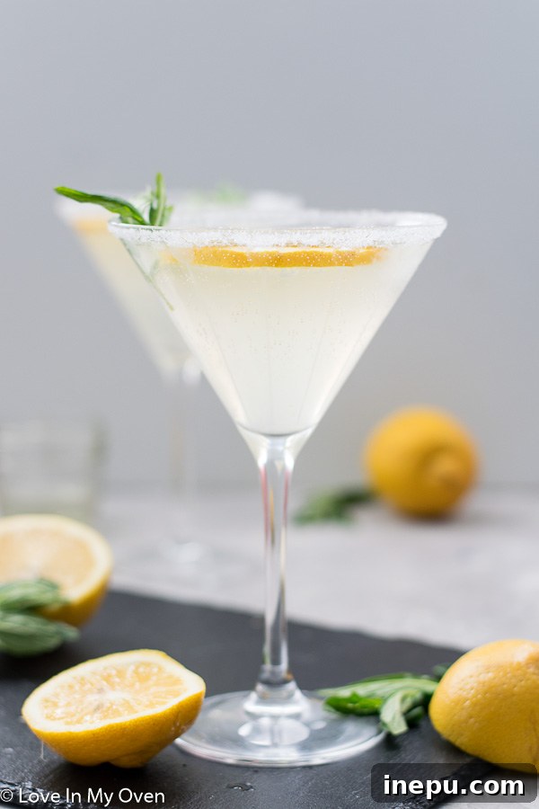 A vibrant lemon vodka cocktail with a lemon slice garnish.