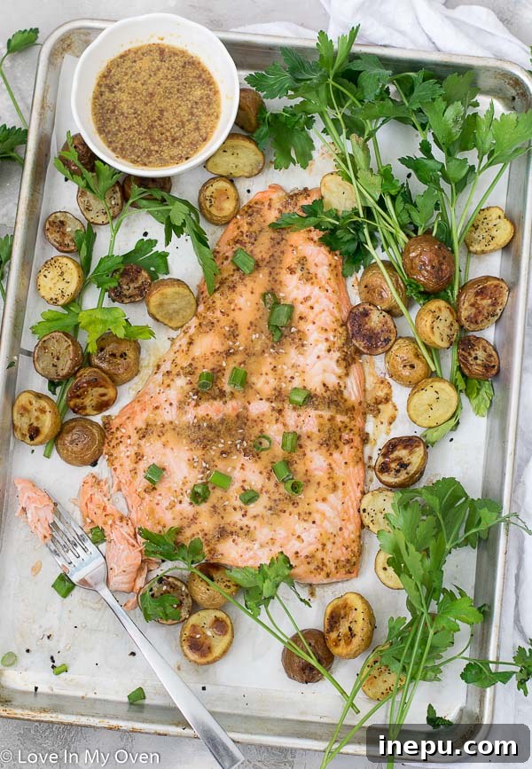 Maple Dijon Salmon being served with roasted potatoes