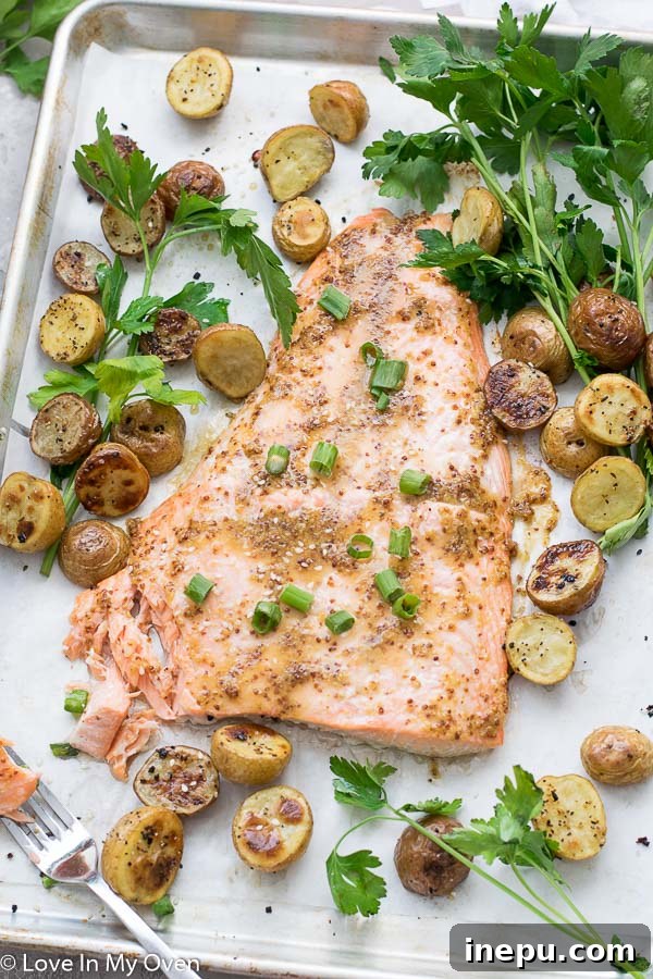 Maple Dijon Salmon with fresh herbs, ready to be served