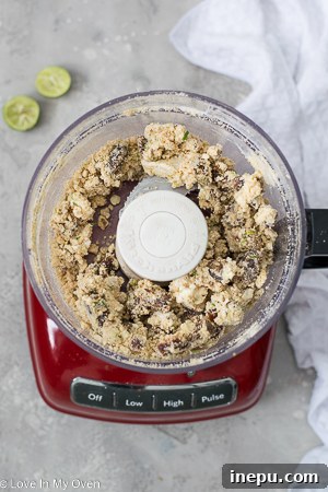 Zesty Key Lime Cheesecake Treats 5 Hand rolling key lime cheesecake mixture, showing texture