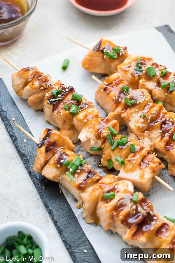 Overhead view of grilled salmon skewers and side dishes ready to eat