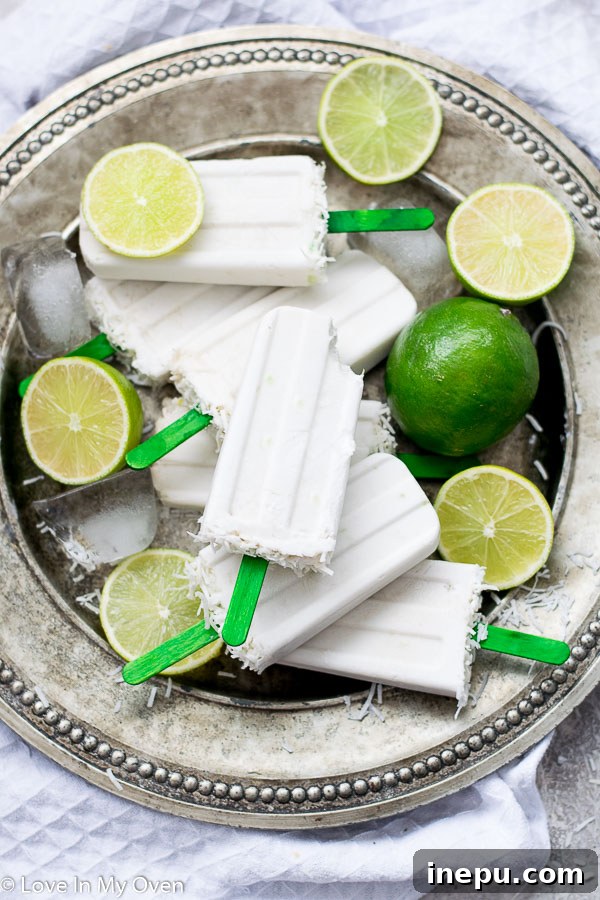 Zesty Coconut Lime Bliss 3 Closeup of creamy coconut lime popsicles with a hint of green zest.