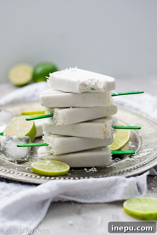 Zesty Coconut Lime Bliss 7 Several coconut lime popsicles arranged artfully, showcasing their vibrant color and texture.