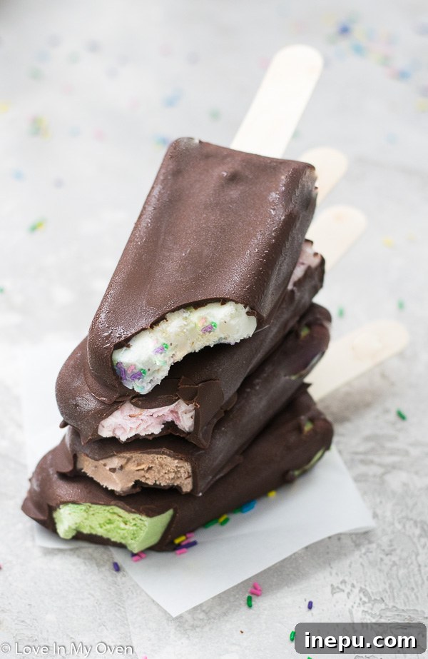 Variety of homemade chocolate dipped ice cream bars in different flavors, including vanilla, matcha, salted caramel, and strawberry