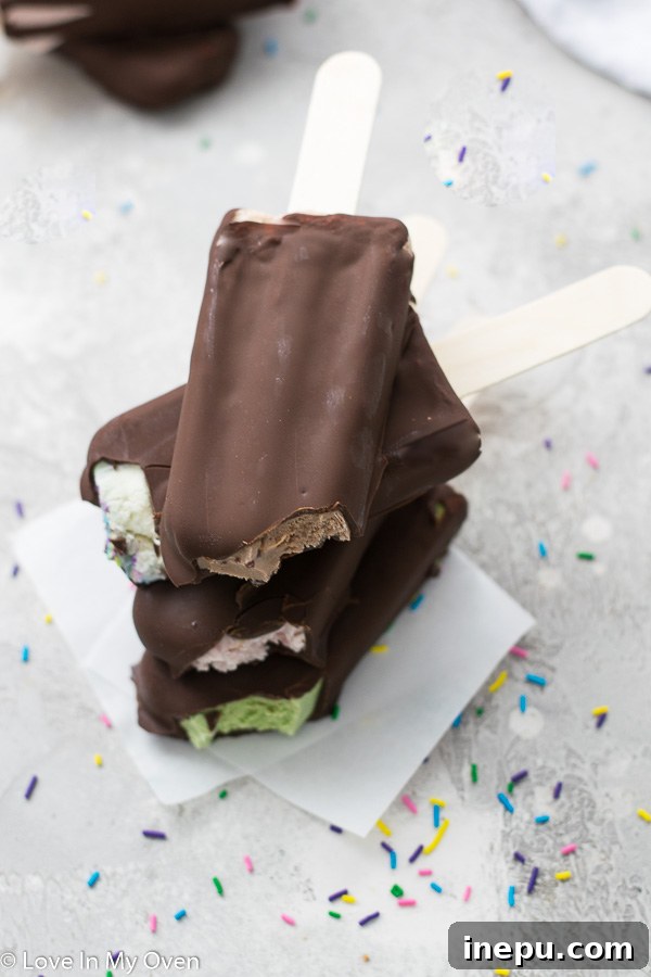 Close-up of a perfectly dipped chocolate ice cream bar with a firm, glossy shell
