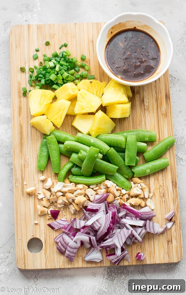 Golden Pineapple Chicken Stir-Fry 4 Prepped ingredients for chicken and pineapple stir fry, ready for quick assembly and cooking.