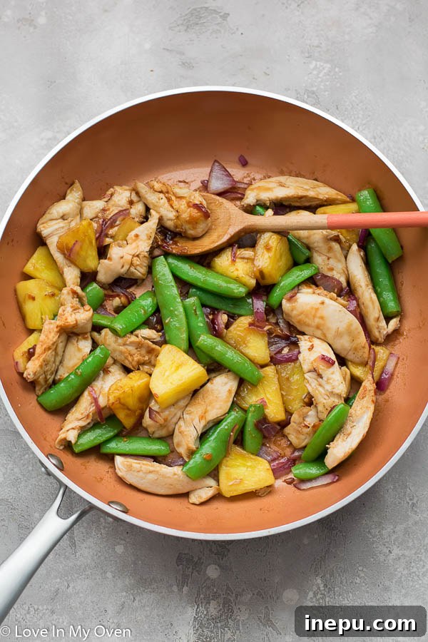 Golden Pineapple Chicken Stir-Fry 6 Finished chicken and pineapple stir fry, ready to be served over rice and garnished with cashews.